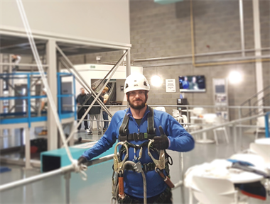 Wind Turbine Engineer in full fall arrest harness at a training facility