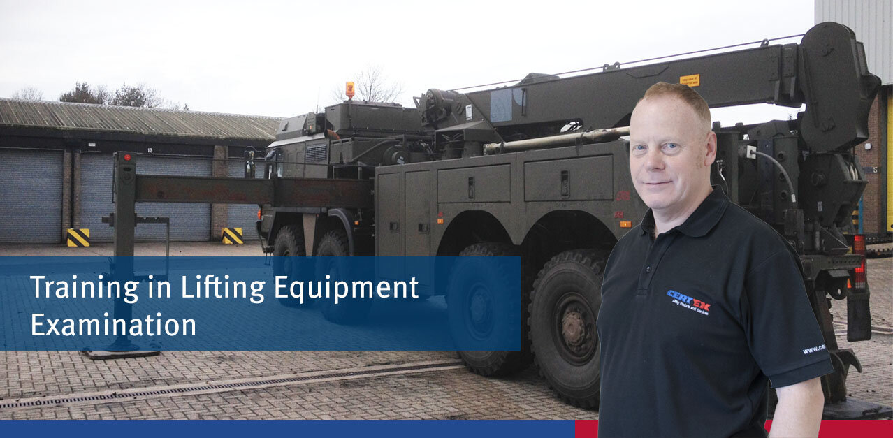 Defence: Training Course in Lifting Equipment Examination A Defence military vehicle for lifting with a trainer in front of it.