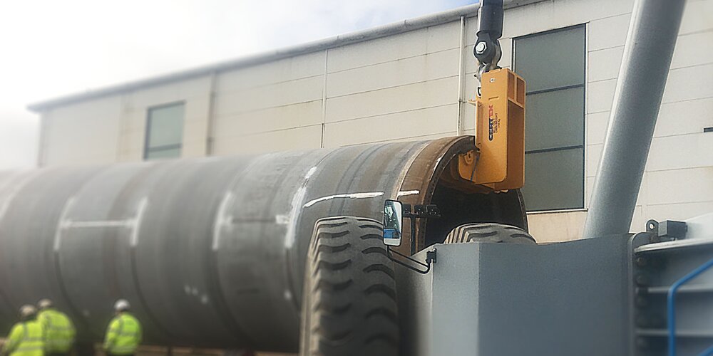 A bespoke lifting hook created by Certex UK lifting a wind turbine tower with a mobile crane
