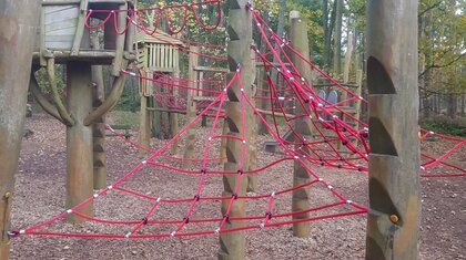 Large adventure-style rope climbing structure for active outdoor playground