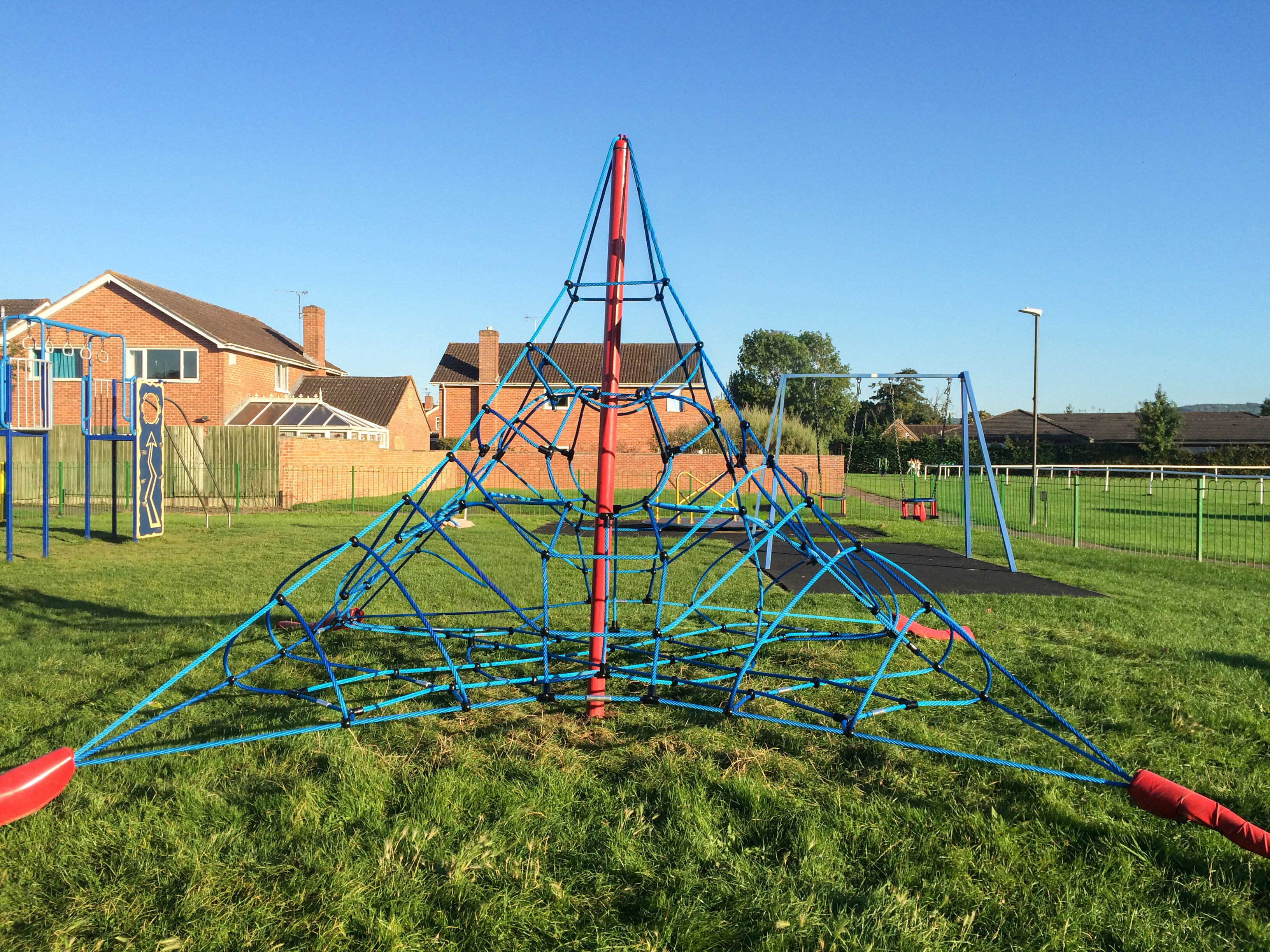 Commercial rope playground structure installed in public park for community use