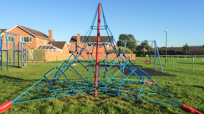 Commercial rope playground structure installed in public park for community use
