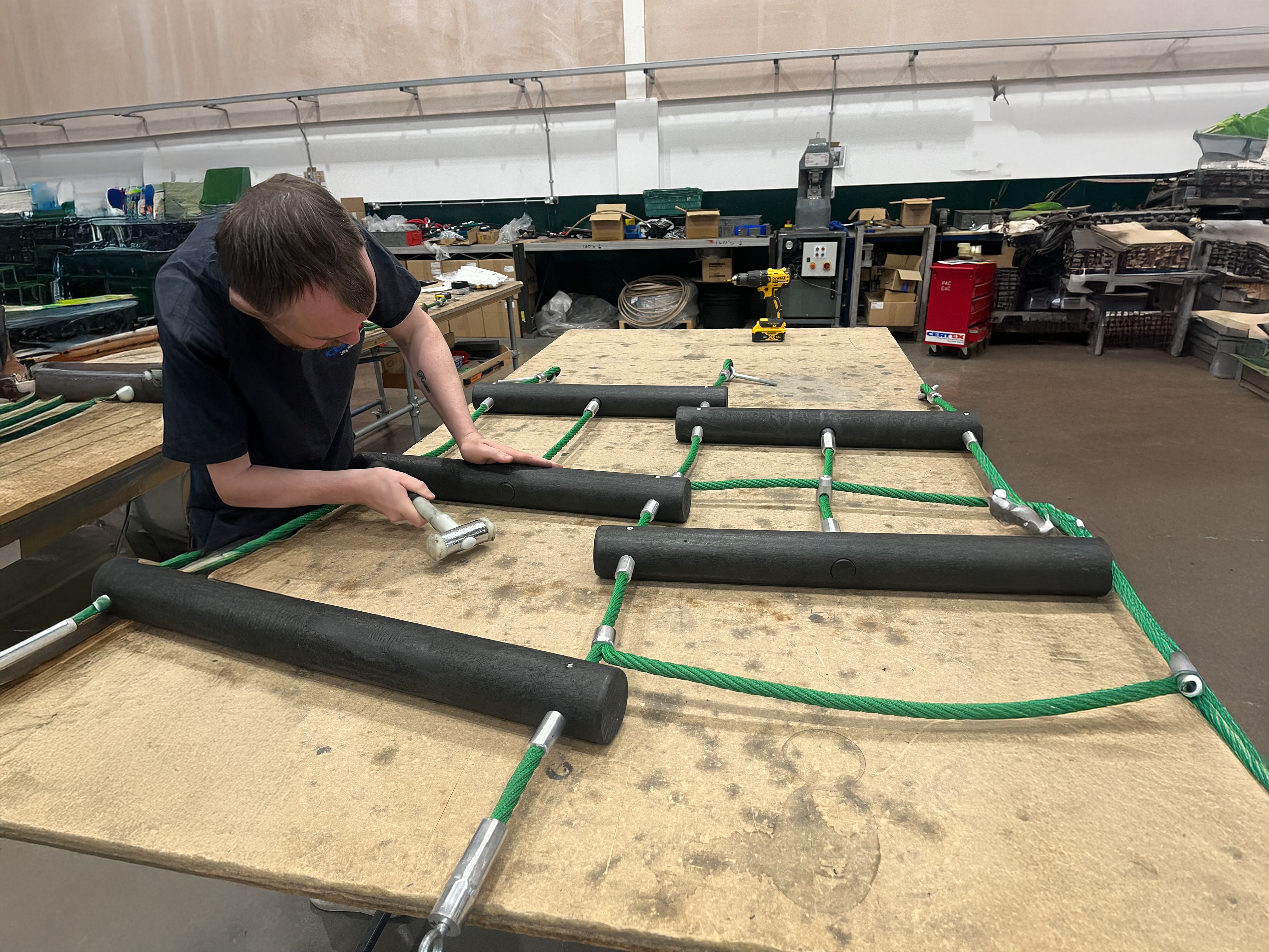 Refurbished playground rope bridge manufactured to replace weathered original