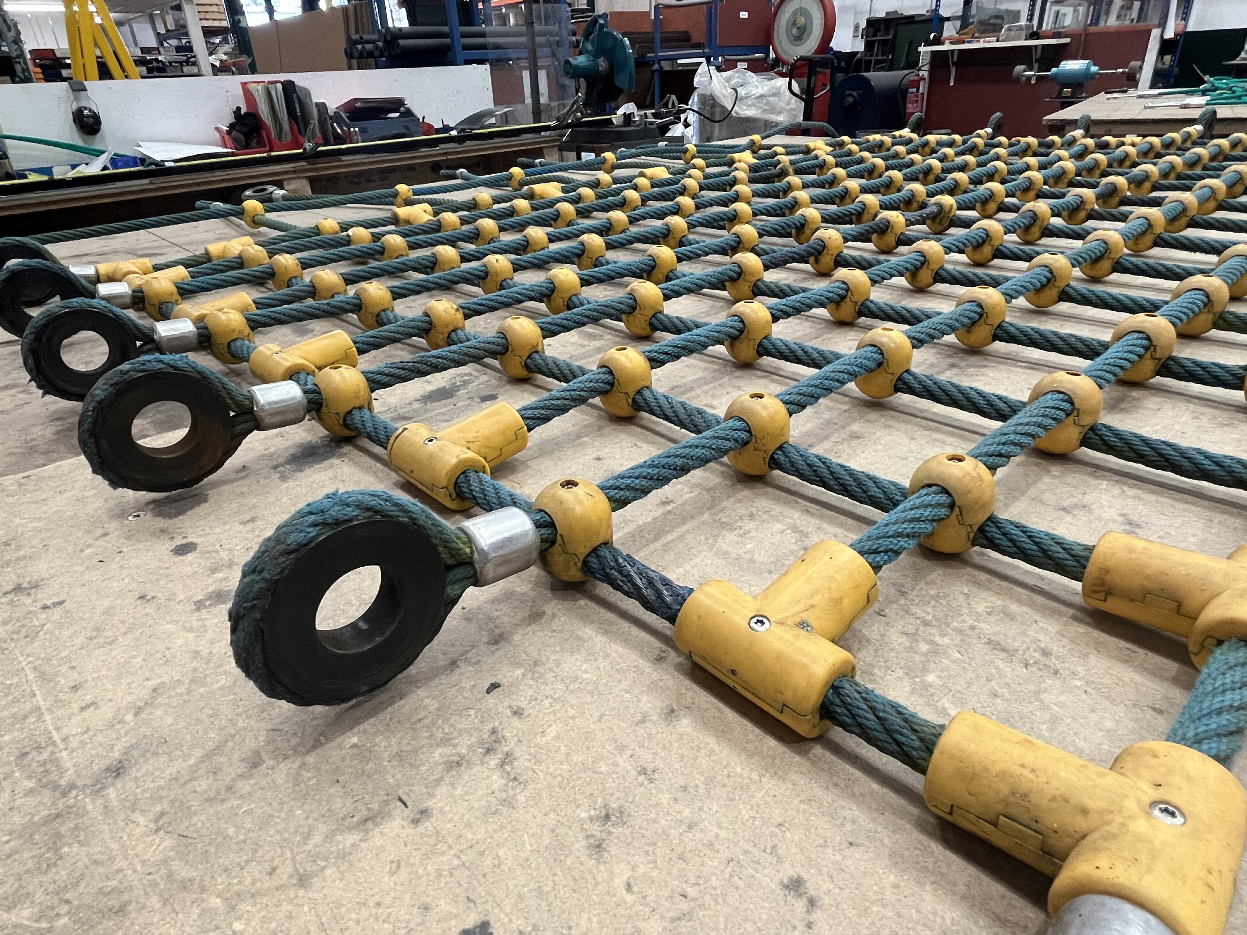 Replacement rope climbing net installed to repair worn playground structure - before