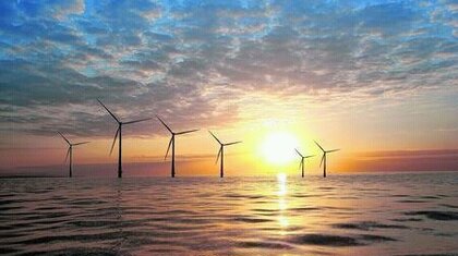 Wind turbines at sea during a sunset