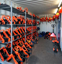 a Metal Storage Container with multiple lifting camps and other lifting apparatus stored inside in vibrant orange